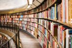 Three things to know before self publishing in Canada - picture of a long curved bookcase in library