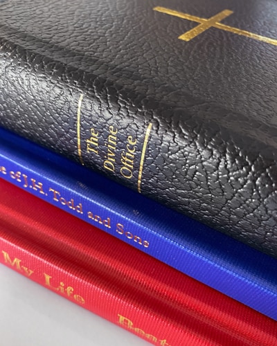 Buckram and leather-style fabric bound hard cover books with foil stamping